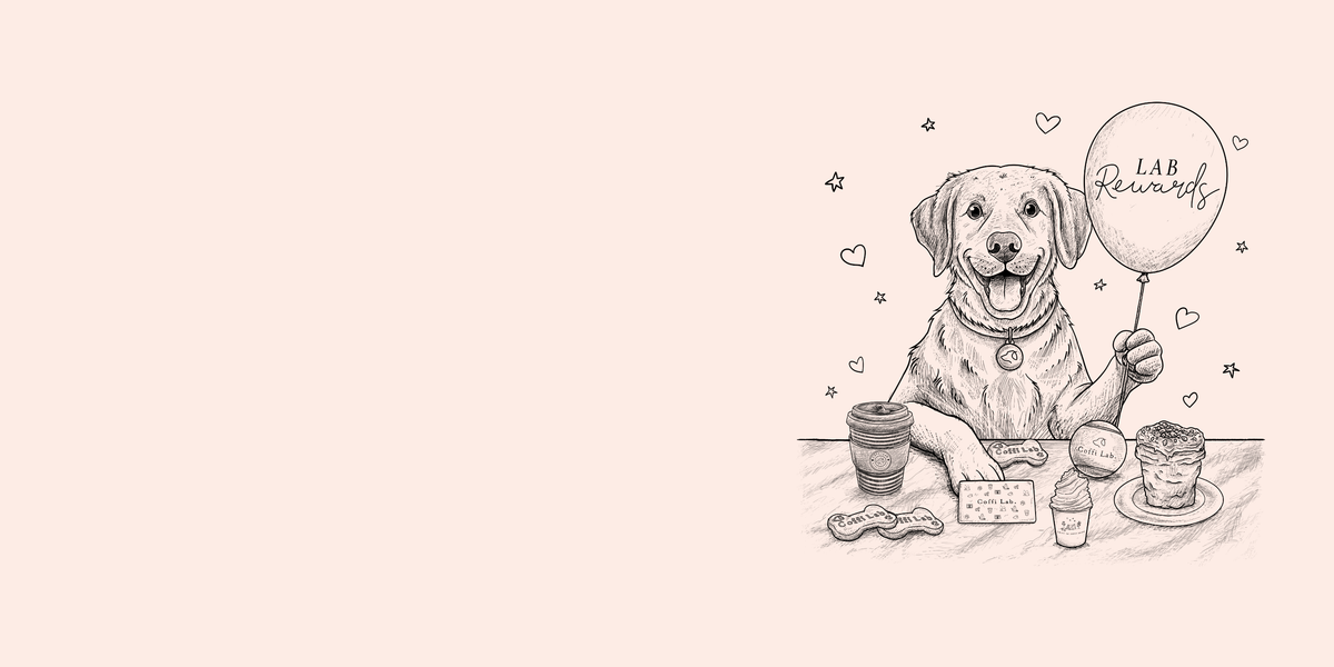 A line drawing of a dog sitting at a table with a coffee cup, snacks, a rewards card, and a balloon labeled “LAB Rewards.”